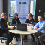 Some of the FPM team grouped around a computer